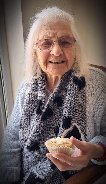 happy elderly lady eating cake